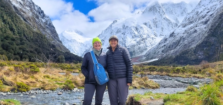 Guests by Milford Road, snow capped mountains in the background