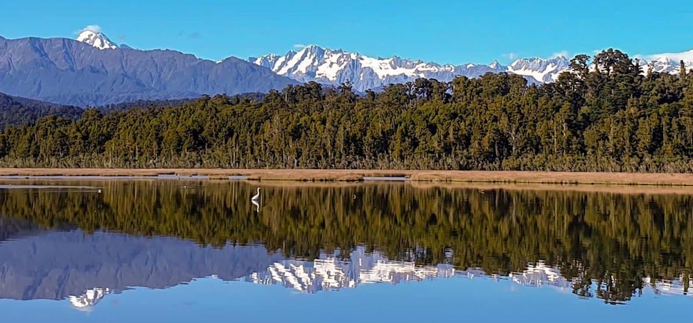 Reflections of the Southern Alps in Okarito Lagoon on the West Coast of New Zealand