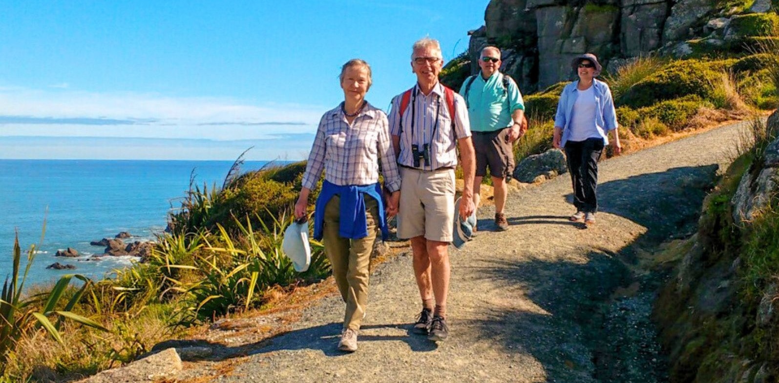 Senior travellers on a coastal walk in New Zealand